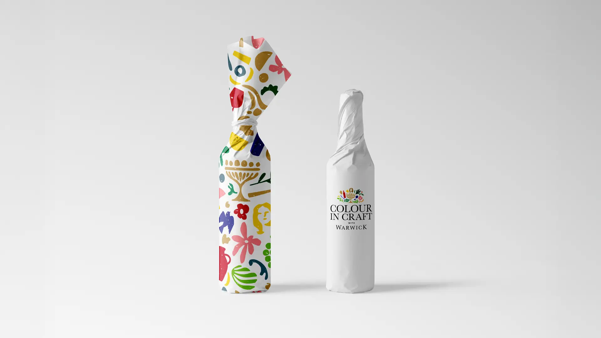 Two wine bottles wrapped in the Colour in Craft pattern and a minimal white campaign label