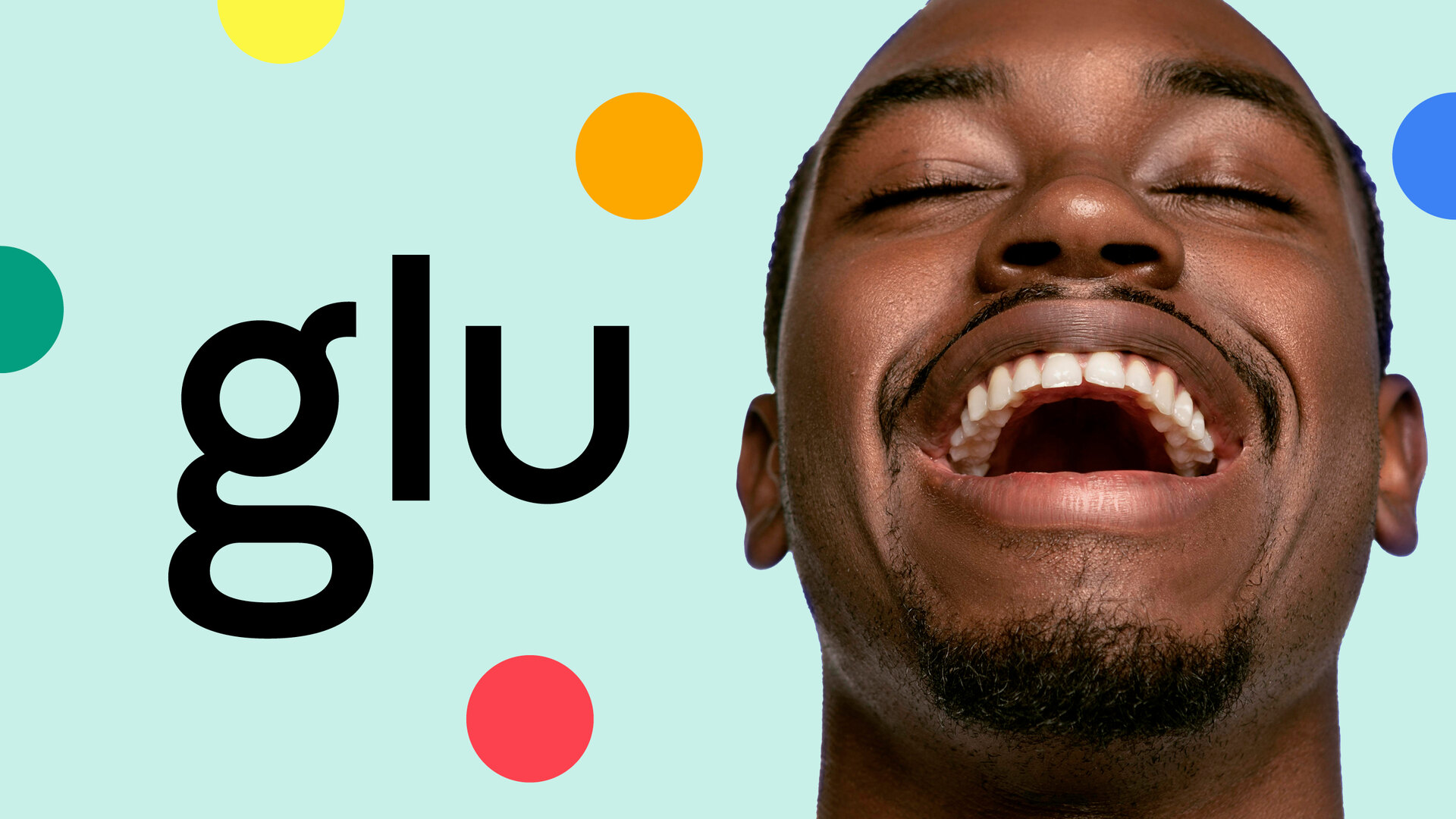 A smiling man with a large glu wordmark and colourful circular graphics